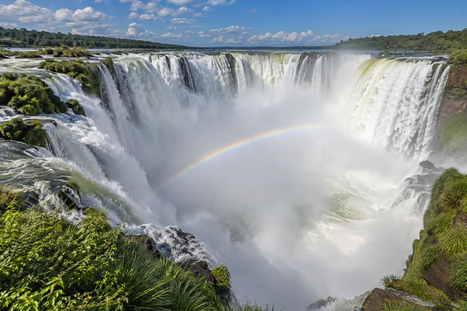 The Devil's Throat of Iguazu Falls with a rainbow, seen from the Argentine side