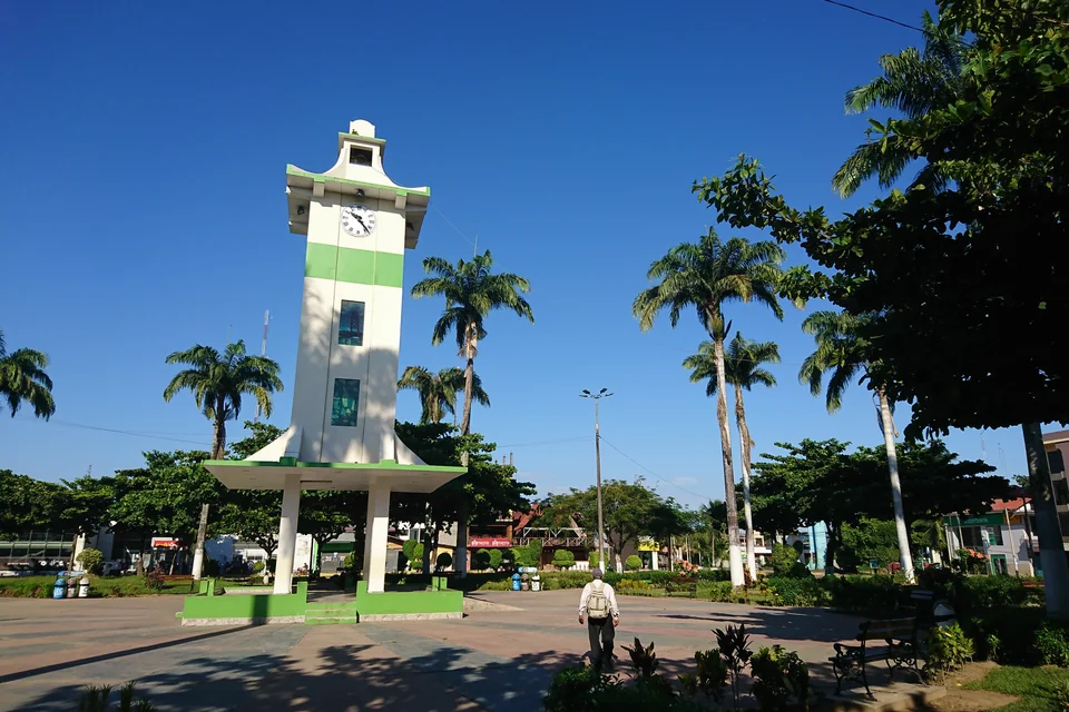 The clock tower and palms on the Plaza de Armas in Puerto Maldonado