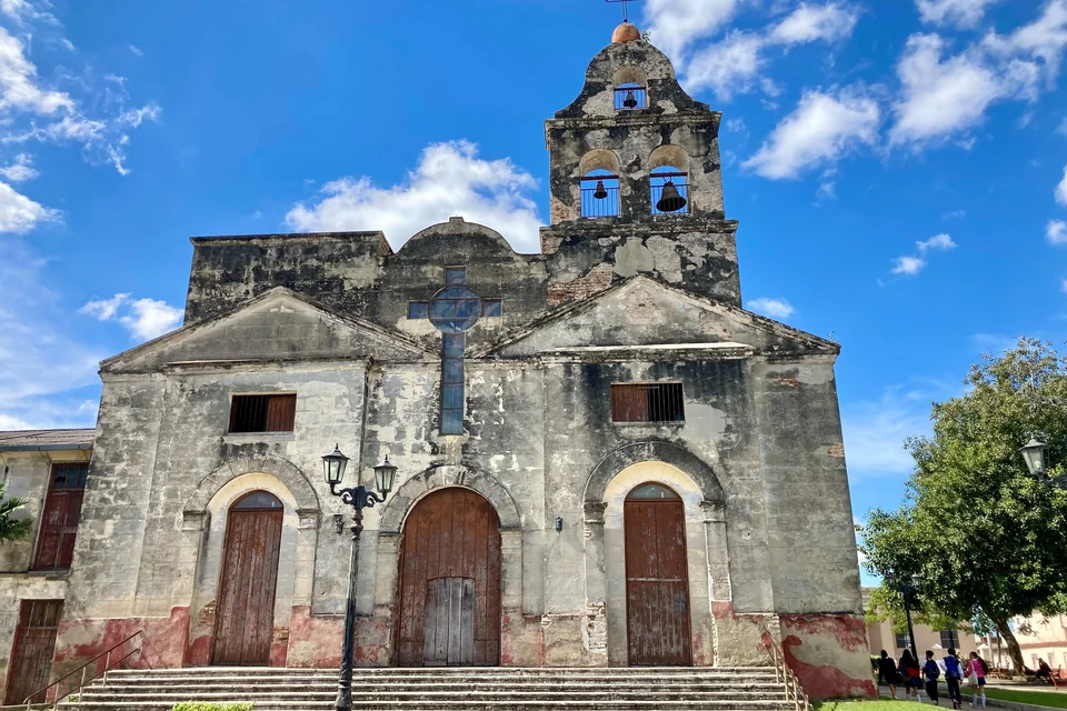 The stone-fronted historic Divina Pastora Church and its bell tower in Santa Clara