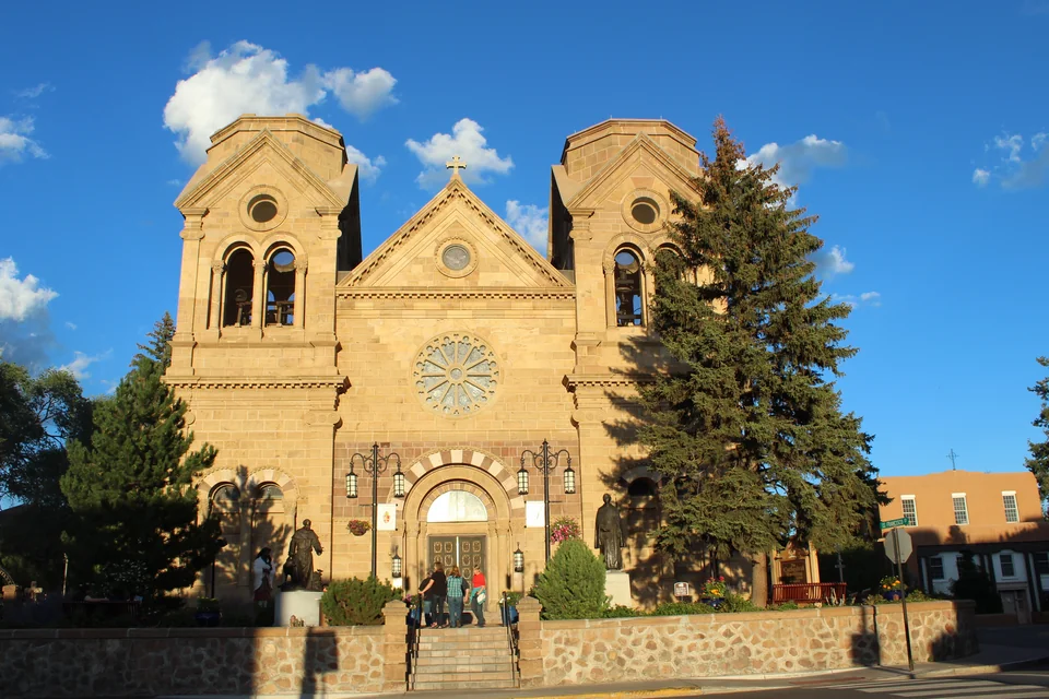The sandstone twin-towered Cathedral of St Francis and a pine tree in Santa Fe