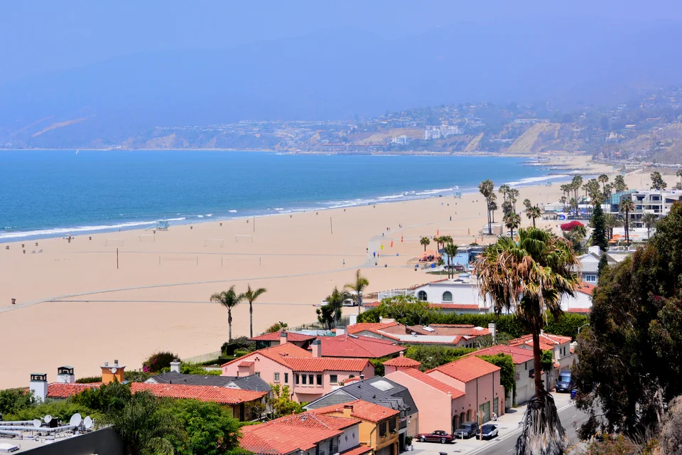 The wide beach, palms and Pacific shore of Santa Monica seen from above