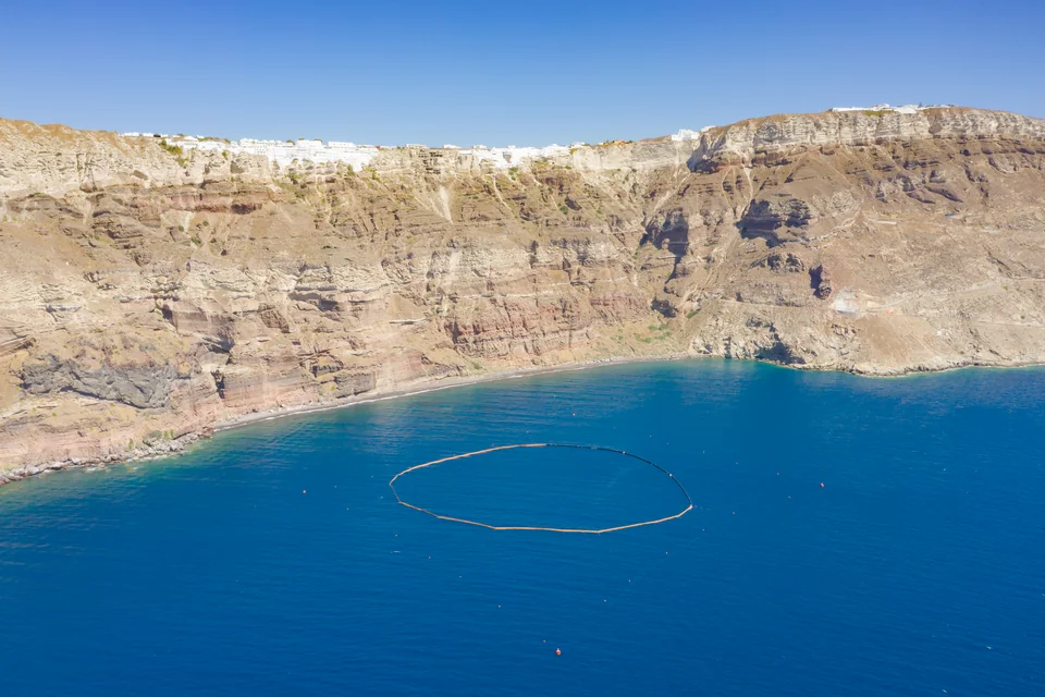 The sheer caldera cliffs of Santorini with white villages along the rim