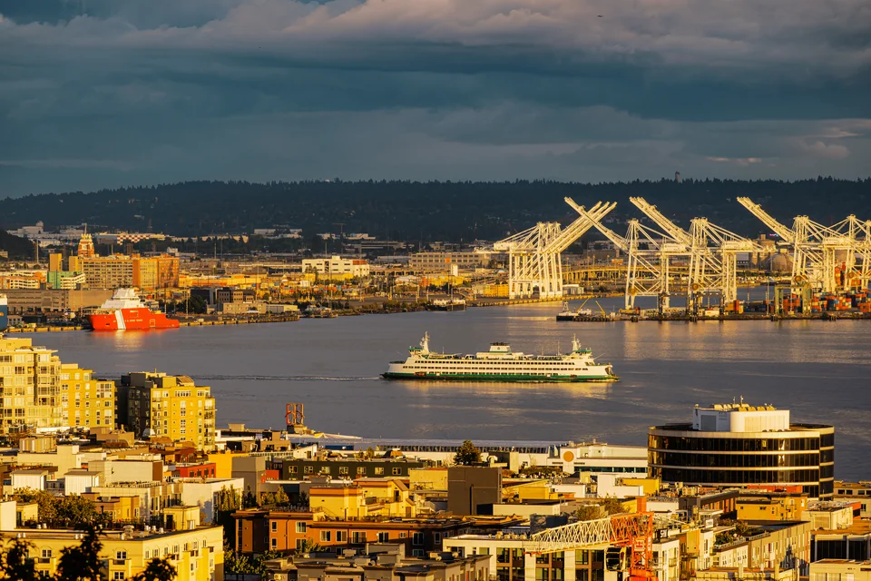 A ferry, port cranes and waterfront buildings on Elliott Bay, Seattle