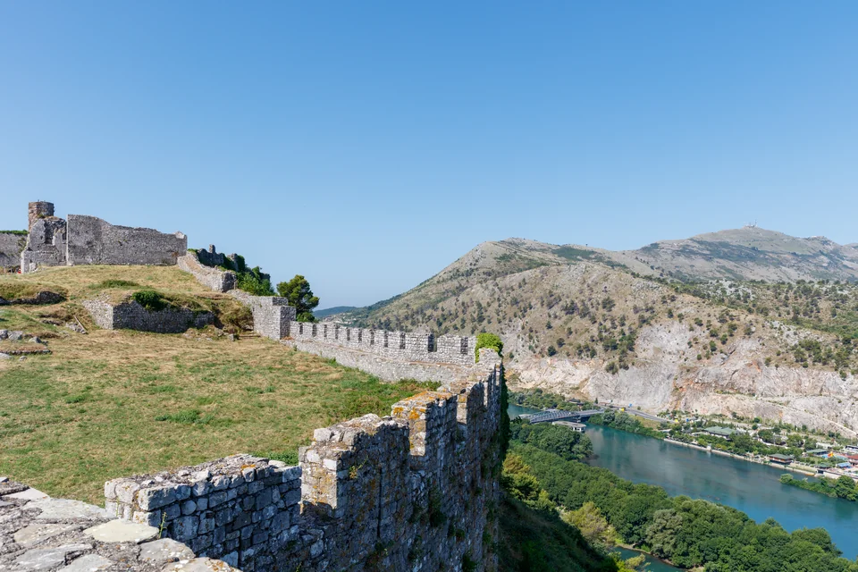 The stone walls of Rozafa Castle above the river in Shkodër