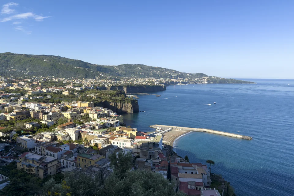 Sheer sea cliffs, the town and green hills along the Sorrento coast
