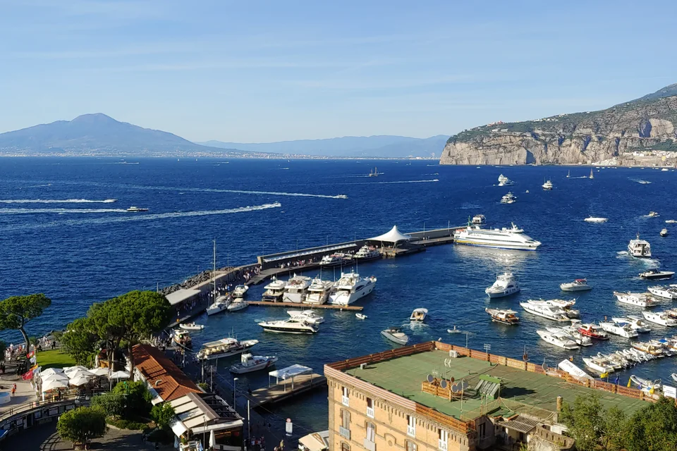 Boats in Sorrento harbour, the Bay of Naples and Mount Vesuvius beyond