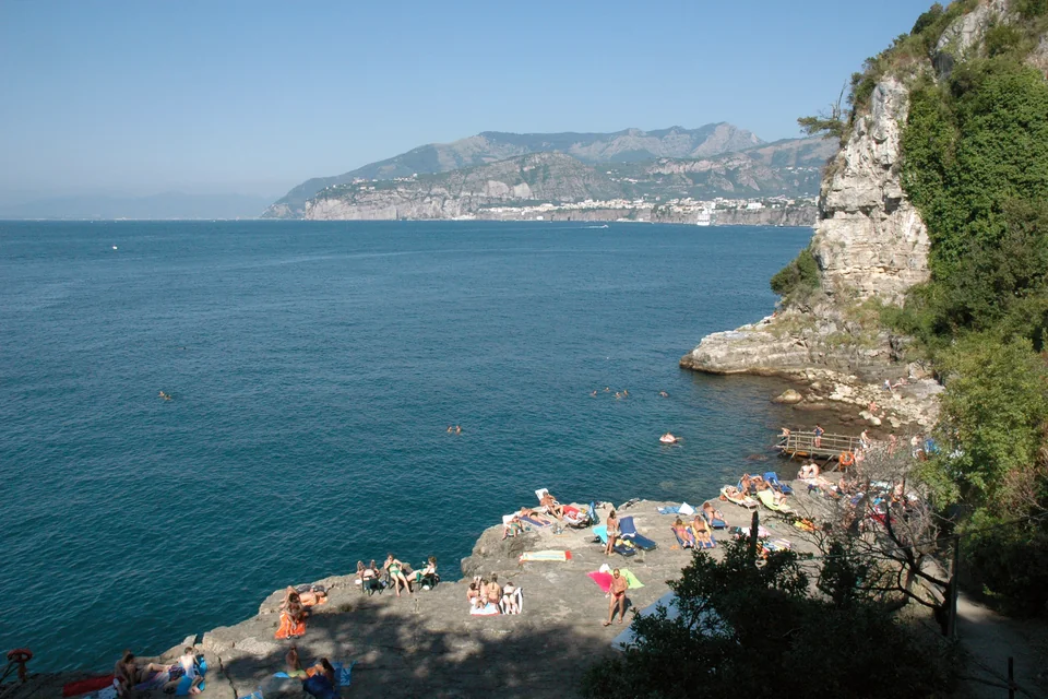 A rocky cove, turquoise sea and the sheer coast opposite at Sorrento