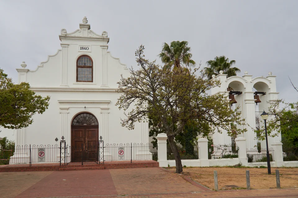 A white Cape Dutch style historic church and its bell tower in Stellenbosch