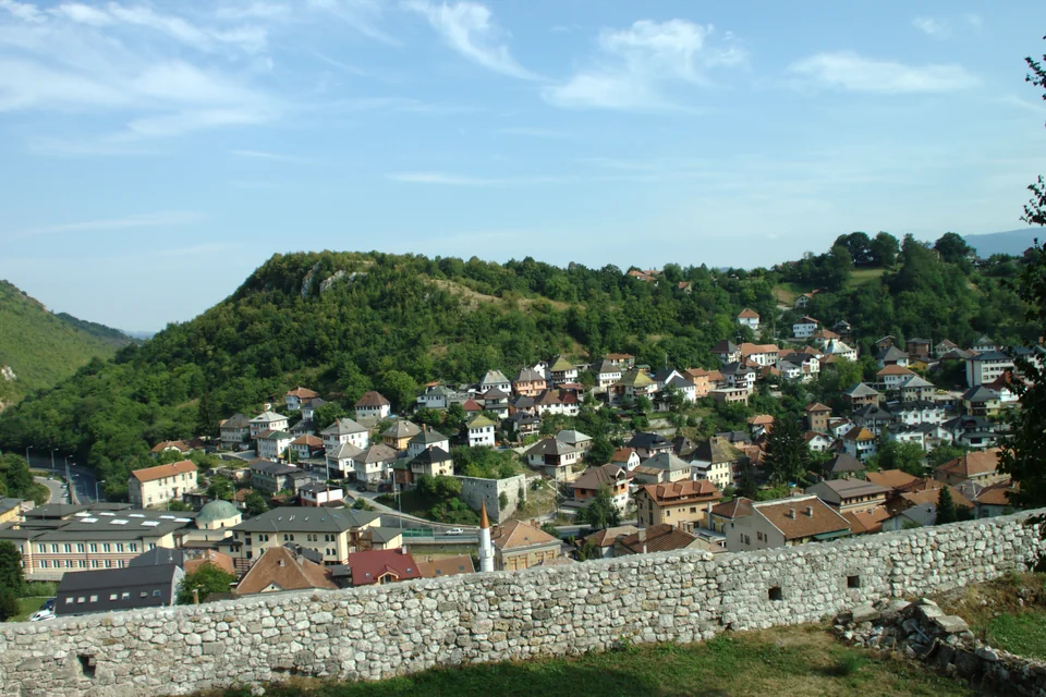 Red-roofed houses in the valley seen from the fortress walls in Travnik