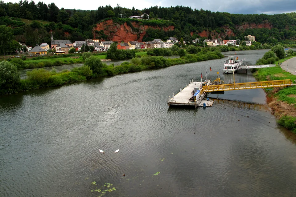 The Moselle River, green banks and red rocky slopes at Trier