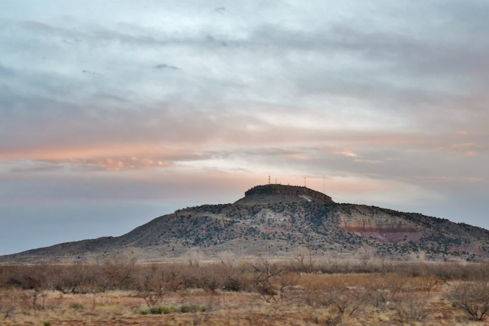 The flat-topped Tucumcari Mountain rising from the plain at sunset