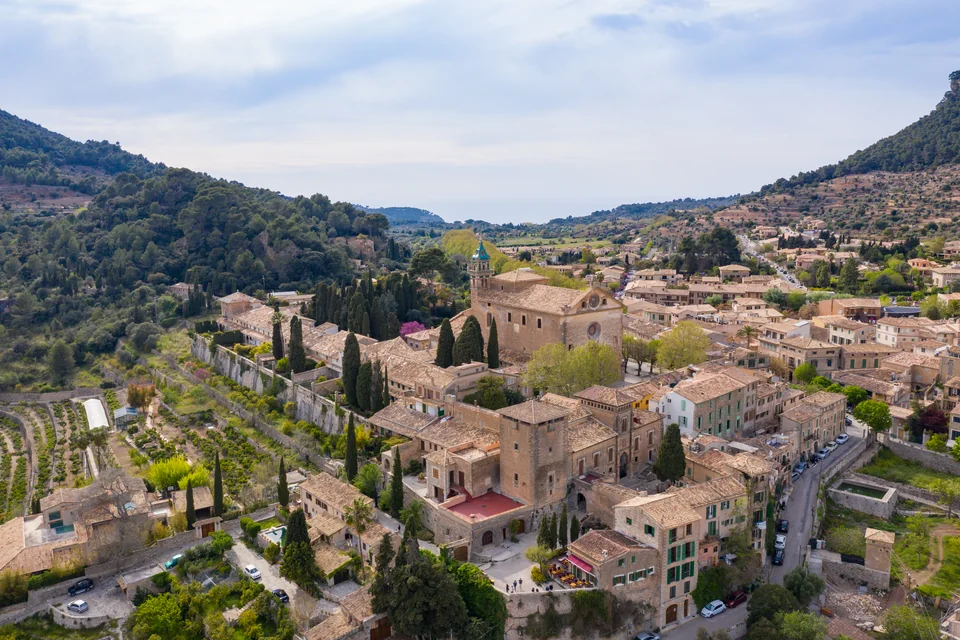 The Charterhouse, cypresses and the stone village ringed by mountains at Valldemossa, from the air