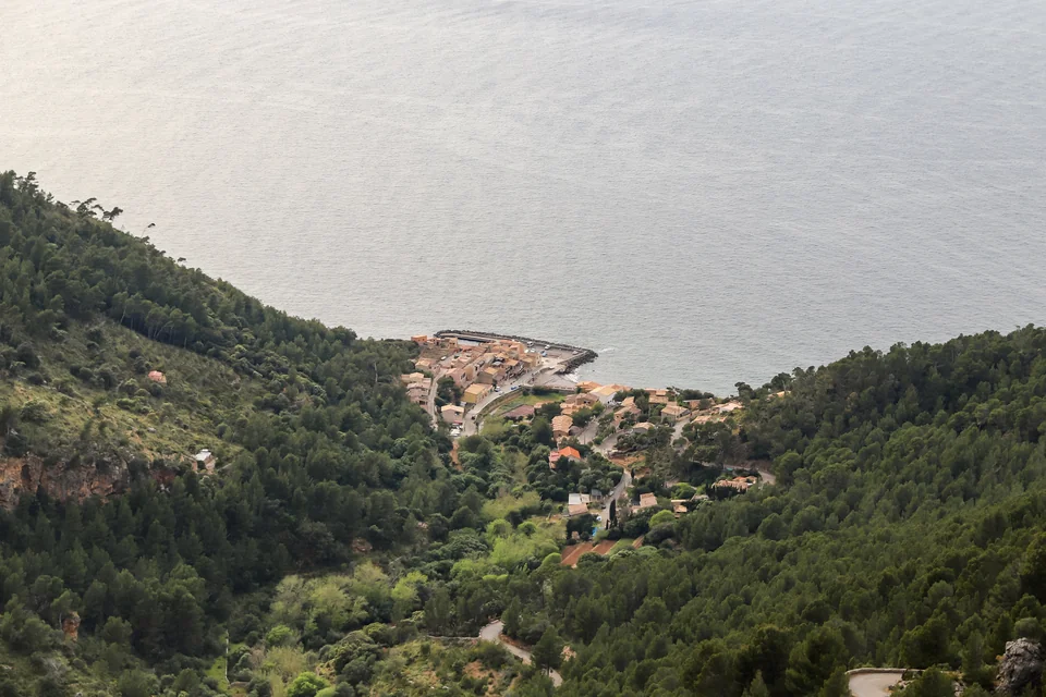 Port de Valldemossa and the Mediterranean seen between forested slopes
