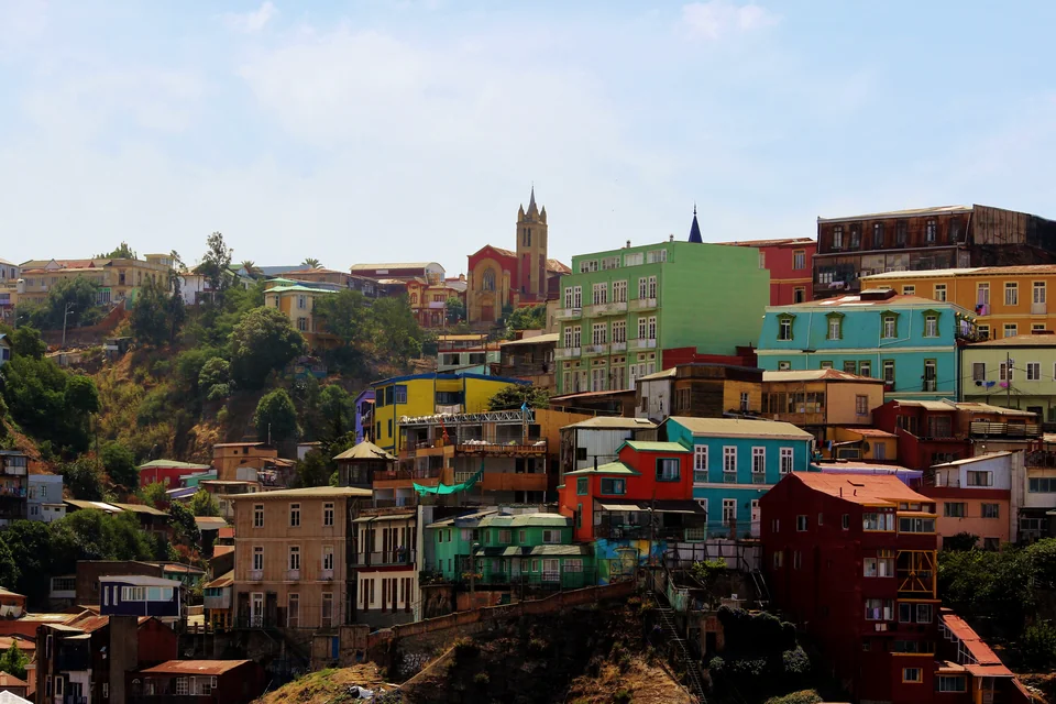 Colourful houses on a steep slope and a bell tower in Valparaíso