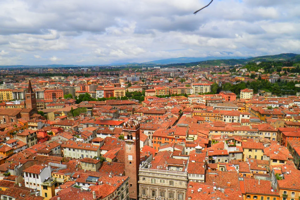 Tiled rooftops and historic towers of Verona seen from above