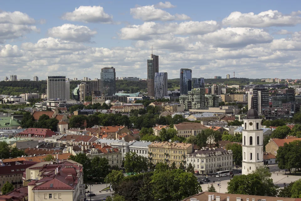 Old town rooftops and the cathedral bell tower with modern towers behind, Vilnius