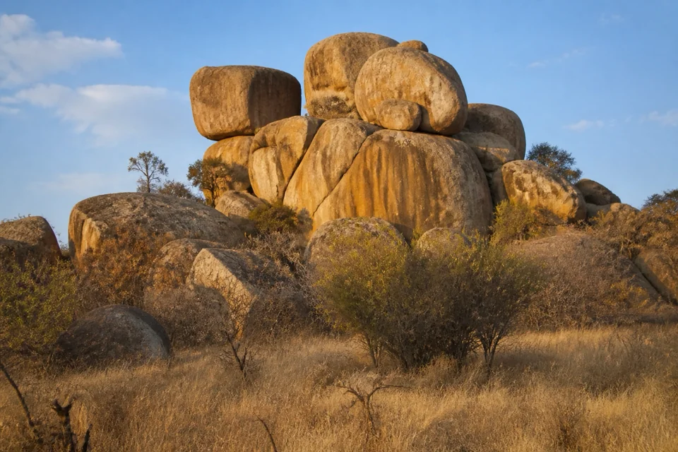 Granite boulders stacked above dry scrub in Zimbabwe