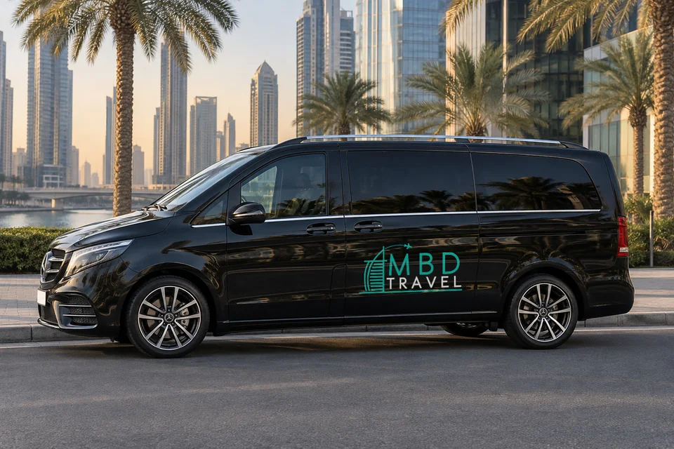 Black Mercedes-Benz Vito with MBD Travel livery beside palms on a Dubai city road, visualization
