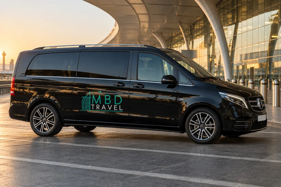Black Mercedes-Benz Vito with MBD Travel livery at DXB terminal at sunset, visualization